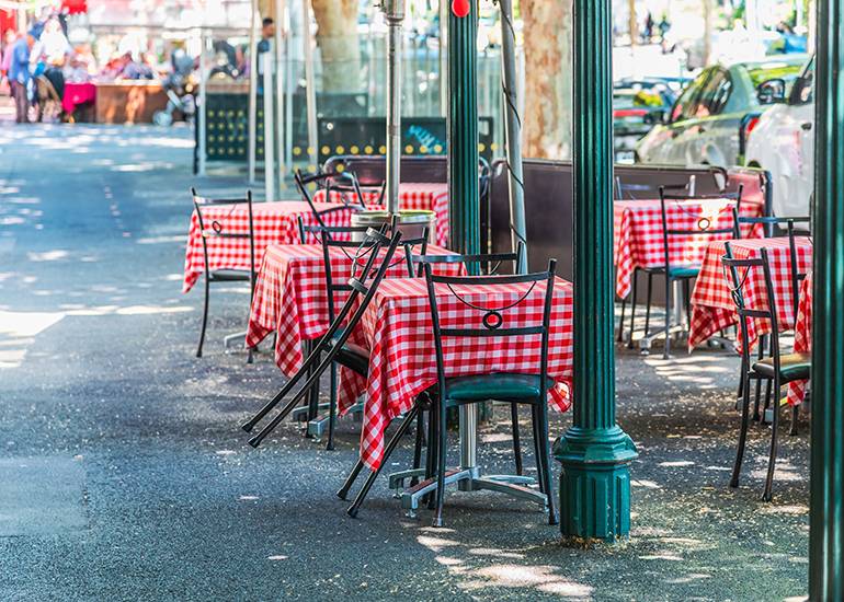 cafe tables on street outside restaurant