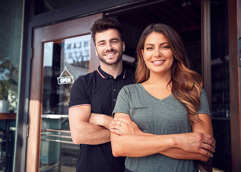 happy couple outside business storefront