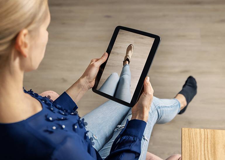 Woman using AR to virtually try on shoes