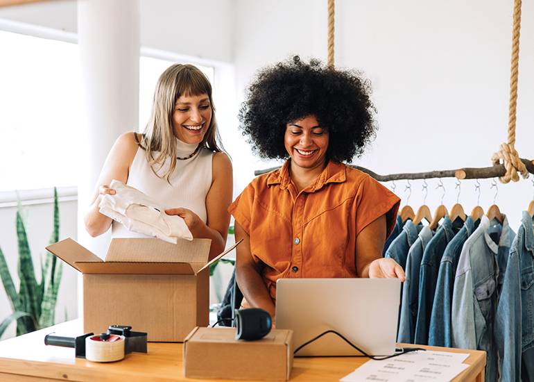 two happy eCommerce business owners in clothing store