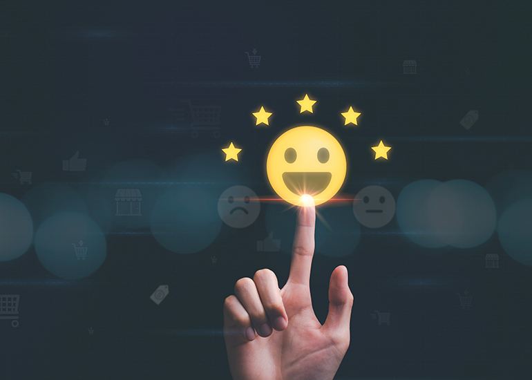 Finger pressing a happy face icon