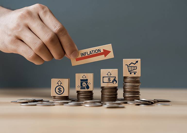 Coin stacks depicting rising costs and inflation