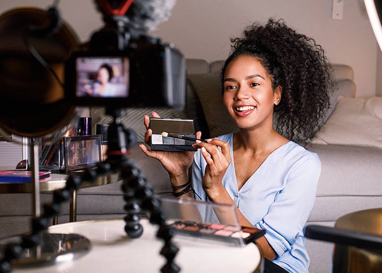 Woman creating social media video with makeup