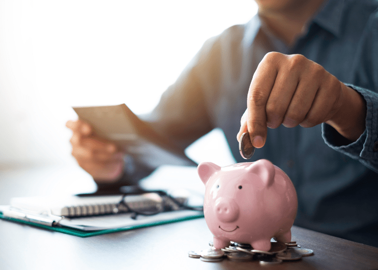 putting money in a piggy bank symbolic of superannuation