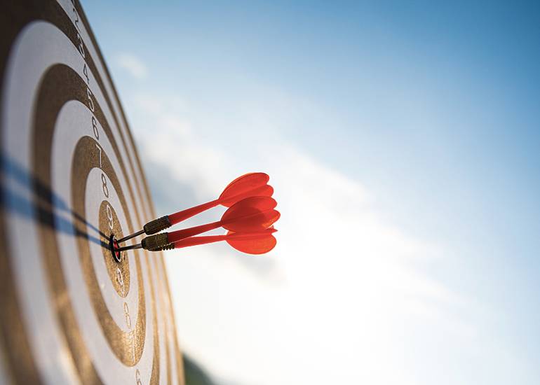 Three arrows hitting bullseye on target