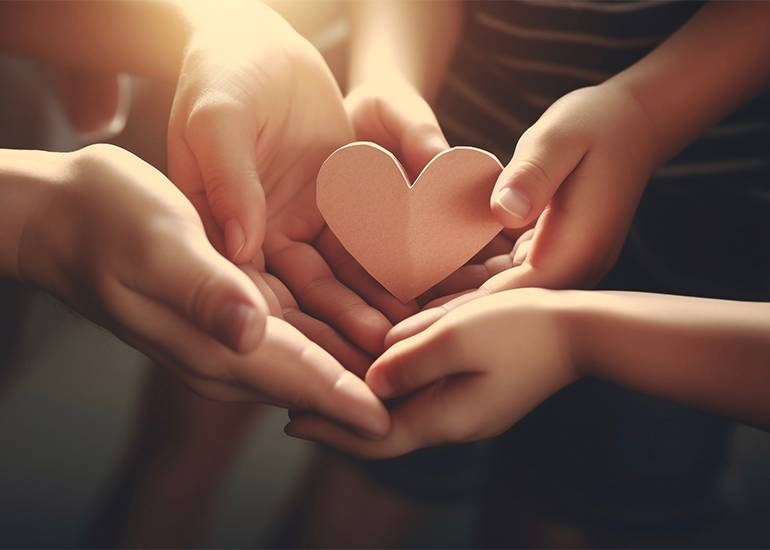 cause concept: hands holding a paper heart