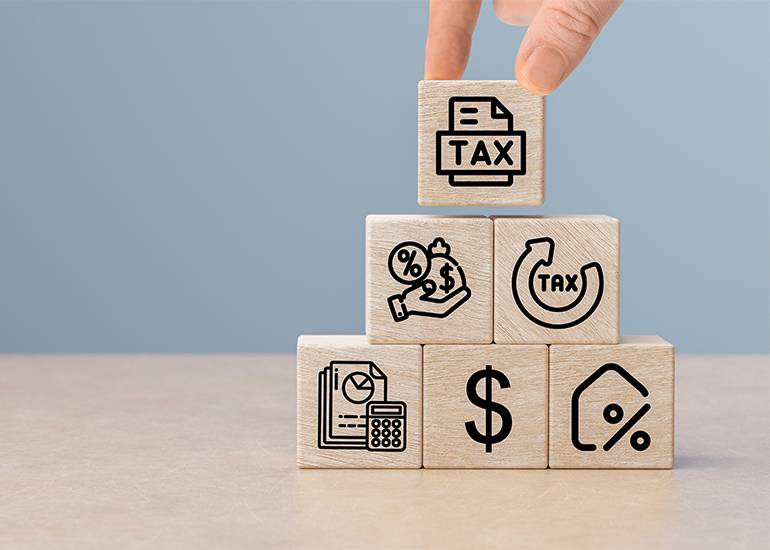 personal service tax - blocks stacked in a pyramid with tax block at teh top.