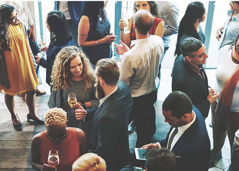 a group of soloists mingle at a networking event