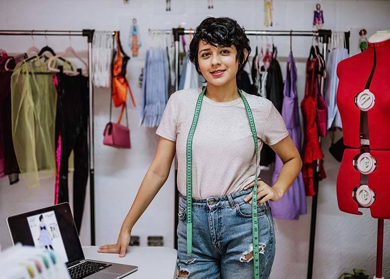 latino fashion designer woman in workshop studio working on her side hustle