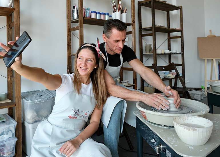 user generated content a couple take a phto of themselves using a pottery wheel