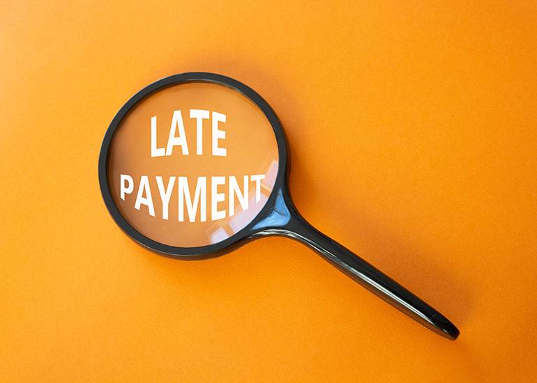 late payment under magnifying glass
